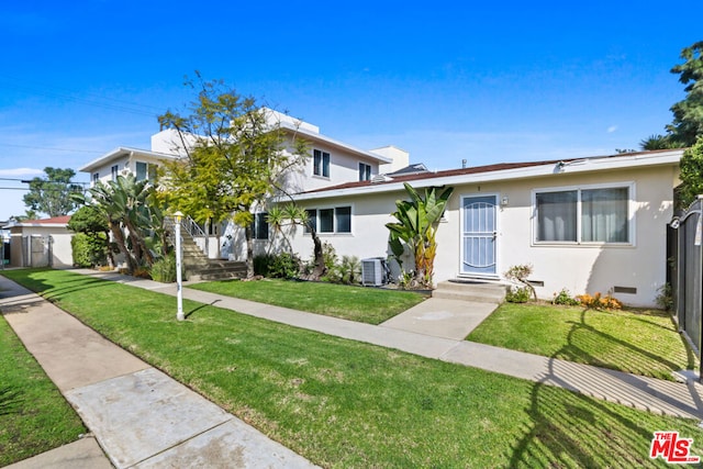 view of front of home featuring a front yard and central AC unit