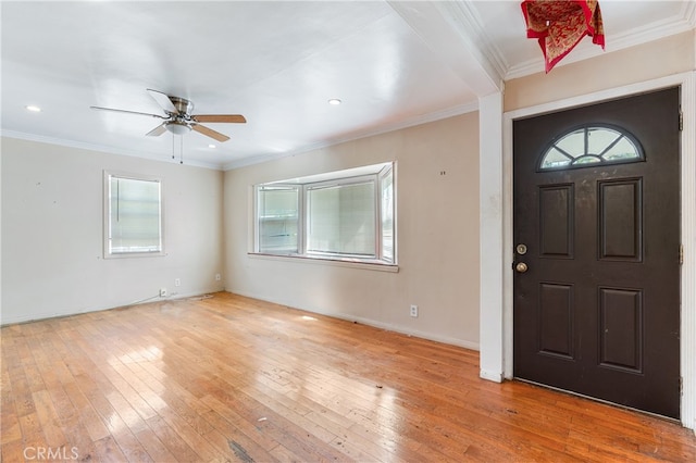 entryway with ceiling fan, crown molding, and light hardwood / wood-style floors