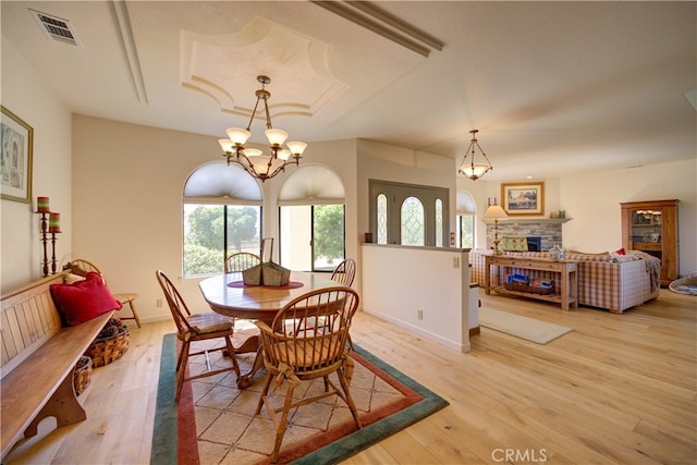 dining room with a chandelier and light hardwood / wood-style floors