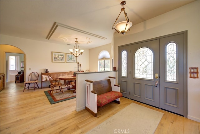 foyer entrance featuring an inviting chandelier and light hardwood / wood-style flooring