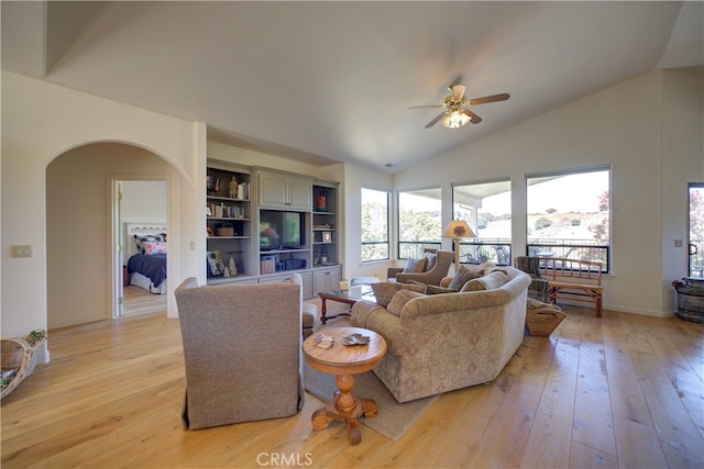 living room featuring light wood-type flooring, vaulted ceiling, and ceiling fan