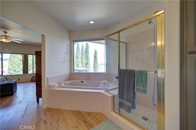 bathroom featuring a healthy amount of sunlight, plus walk in shower, and hardwood / wood-style flooring