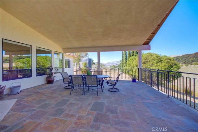 view of patio with a balcony and a mountain view