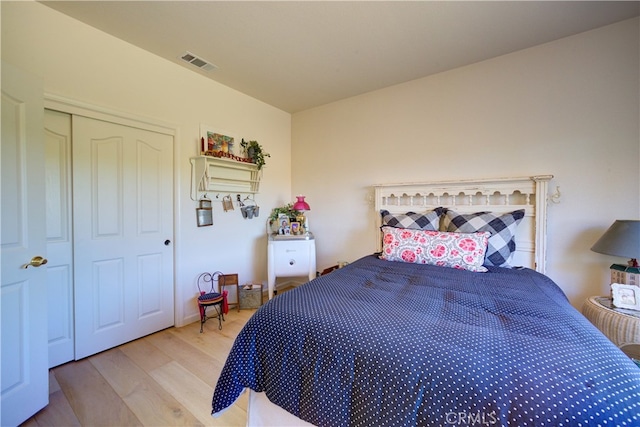 bedroom with light hardwood / wood-style flooring and a closet