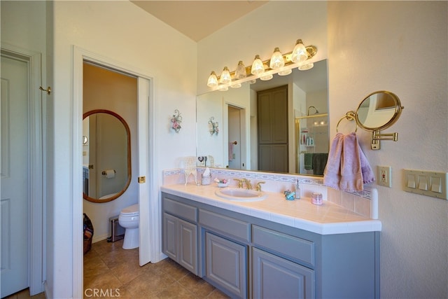 bathroom featuring tile patterned flooring, vanity, and toilet