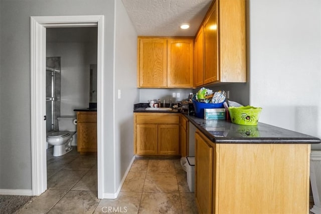 kitchen with light tile patterned floors and a textured ceiling