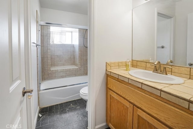 full bathroom featuring vanity, bath / shower combo with glass door, toilet, and tile patterned flooring