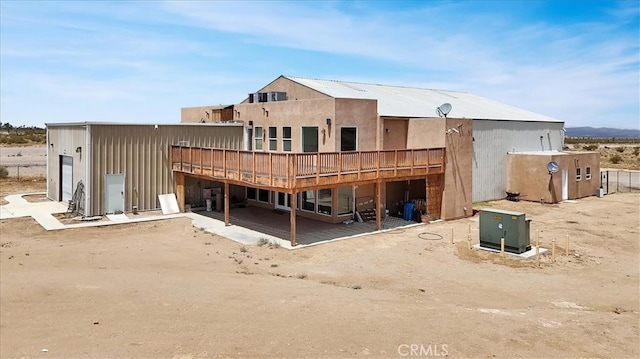 rear view of property with a patio and a wooden deck