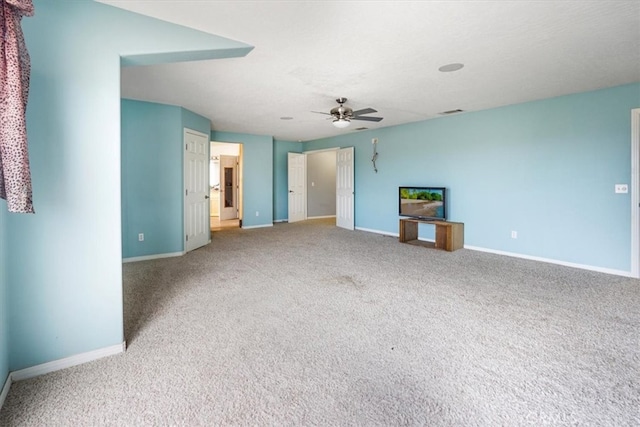 unfurnished living room with ceiling fan and carpet