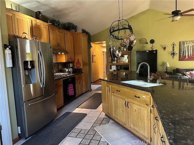 kitchen with sink, decorative light fixtures, vaulted ceiling, light tile patterned floors, and black appliances