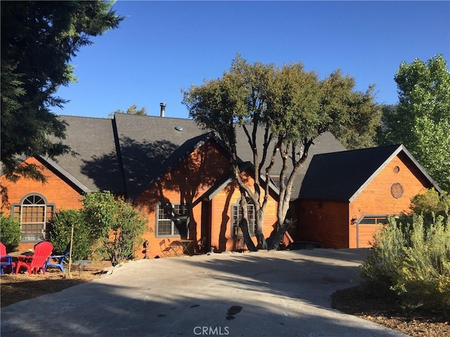 view of front of house featuring concrete driveway and a garage