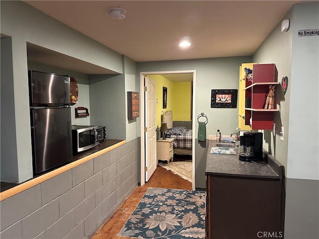 kitchen with hardwood / wood-style floors, sink, and stainless steel appliances