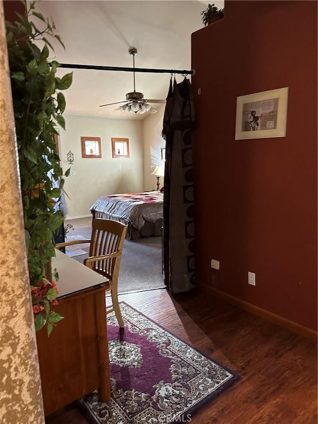 bedroom with baseboards and wood finished floors