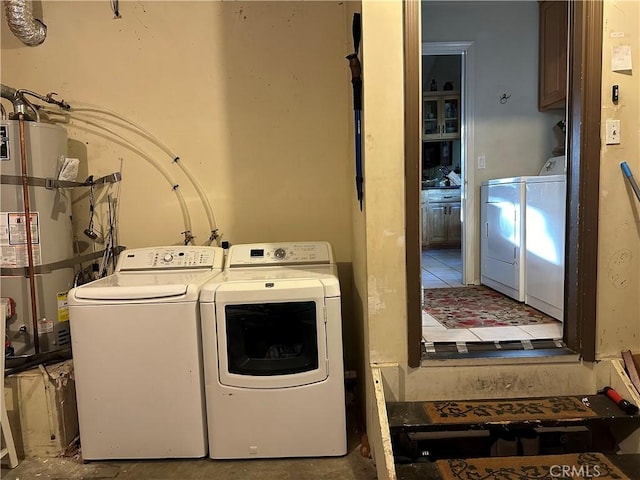 clothes washing area with secured water heater, washer and dryer, and laundry area