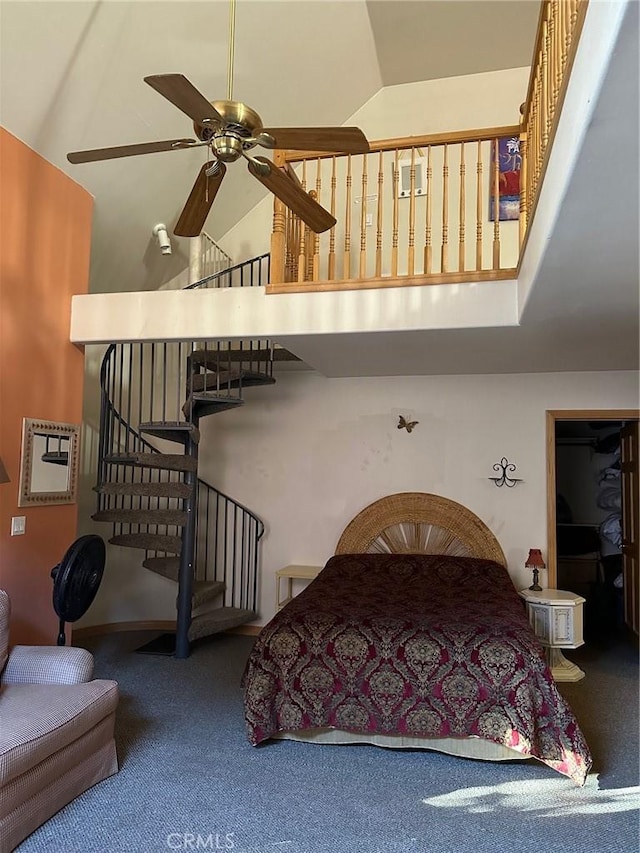 bedroom with carpet, ceiling fan, and vaulted ceiling