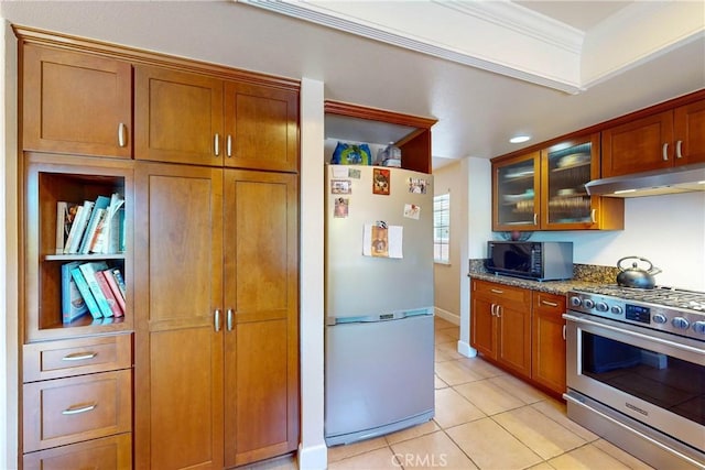 kitchen with light stone countertops, appliances with stainless steel finishes, light tile patterned flooring, and crown molding