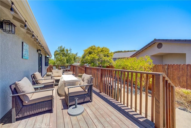 wooden deck featuring an outdoor living space