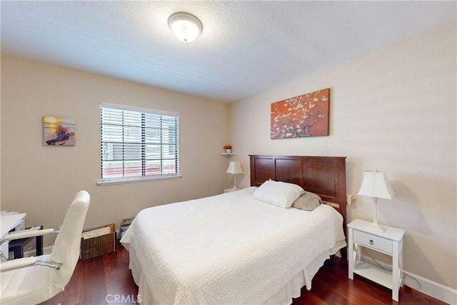 bedroom featuring dark hardwood / wood-style flooring