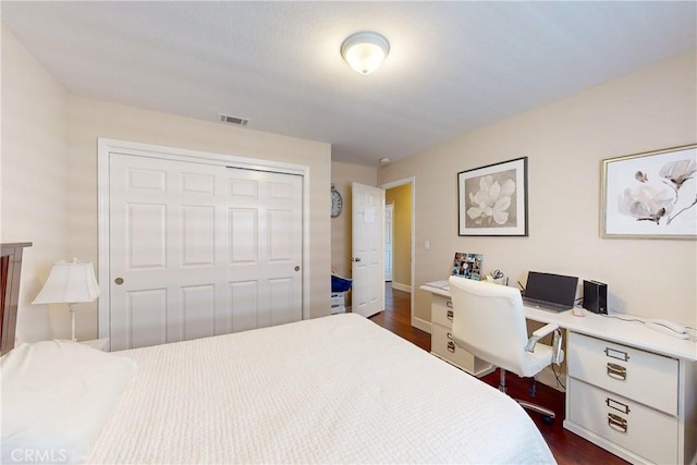 bedroom with a closet and dark hardwood / wood-style floors