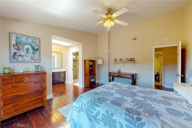 bedroom featuring dark wood-type flooring, ceiling fan, ensuite bathroom, and vaulted ceiling