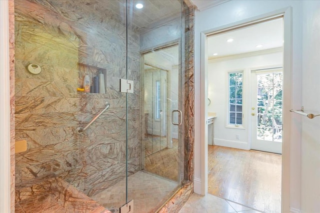 bathroom with walk in shower and ornamental molding