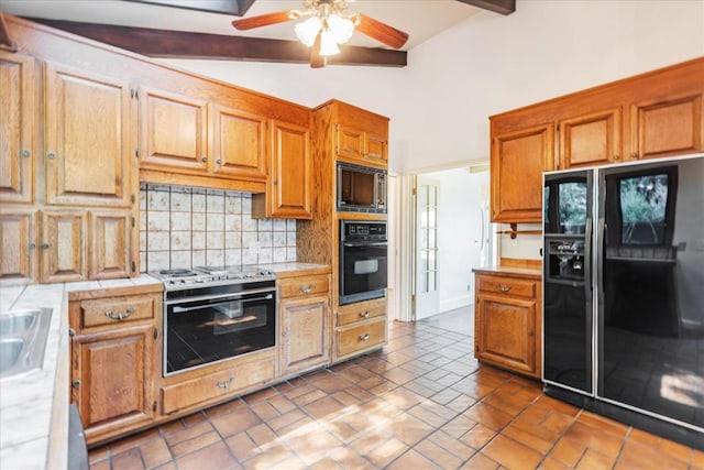 kitchen featuring sink, ceiling fan, lofted ceiling with beams, black appliances, and decorative backsplash