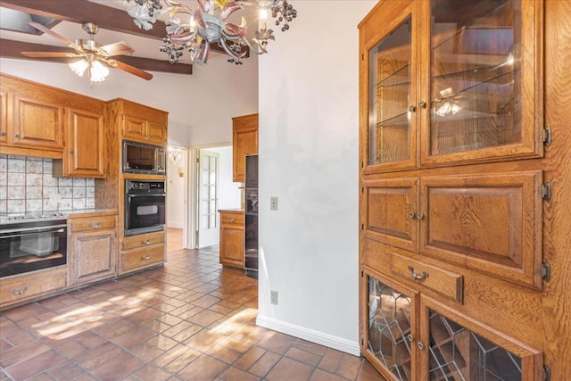 kitchen featuring vaulted ceiling, ceiling fan with notable chandelier, backsplash, and black appliances