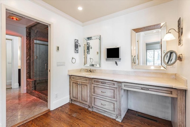 bathroom featuring vanity, hardwood / wood-style floors, crown molding, and a shower with shower door