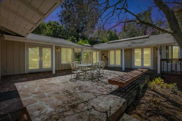 patio terrace at dusk featuring french doors