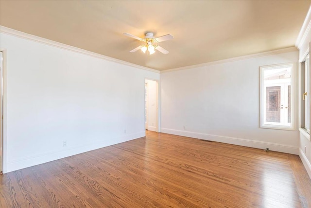 spare room featuring crown molding, ceiling fan, and hardwood / wood-style flooring