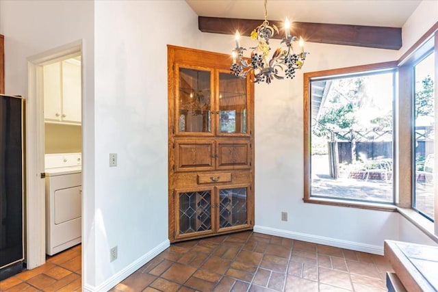 unfurnished dining area with beamed ceiling, washer / dryer, and a chandelier