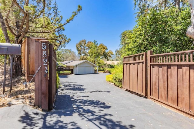 view of gate with an outdoor structure