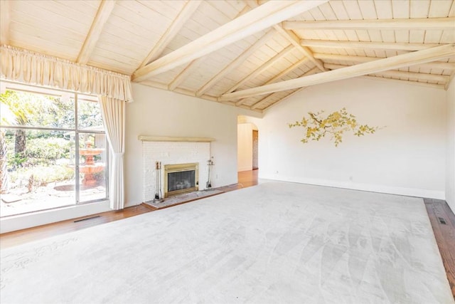 unfurnished living room with lofted ceiling with beams, a brick fireplace, hardwood / wood-style floors, and wooden ceiling