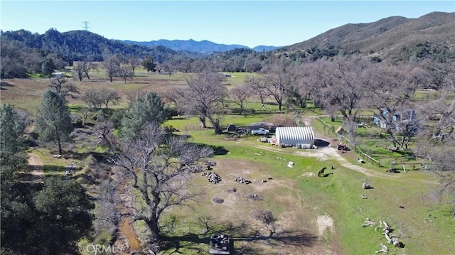 birds eye view of property with a mountain view and a rural view