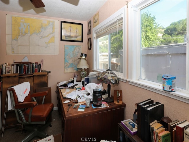 office with ceiling fan and a textured ceiling