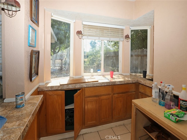 kitchen with a wealth of natural light, tile countertops, and light tile patterned flooring