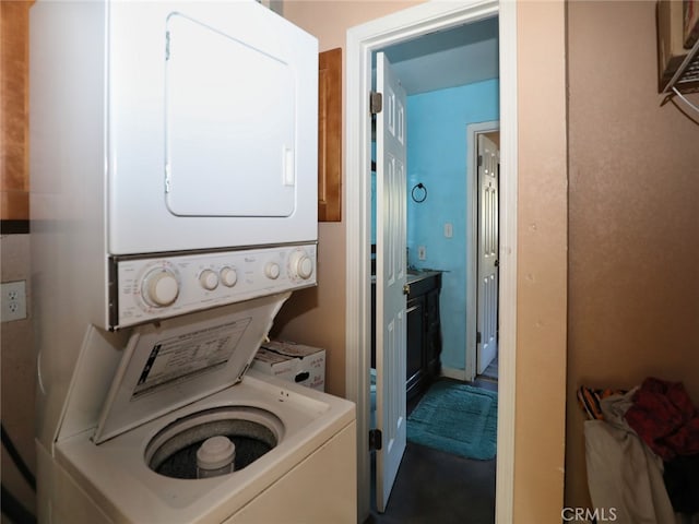 laundry room featuring stacked washer / dryer