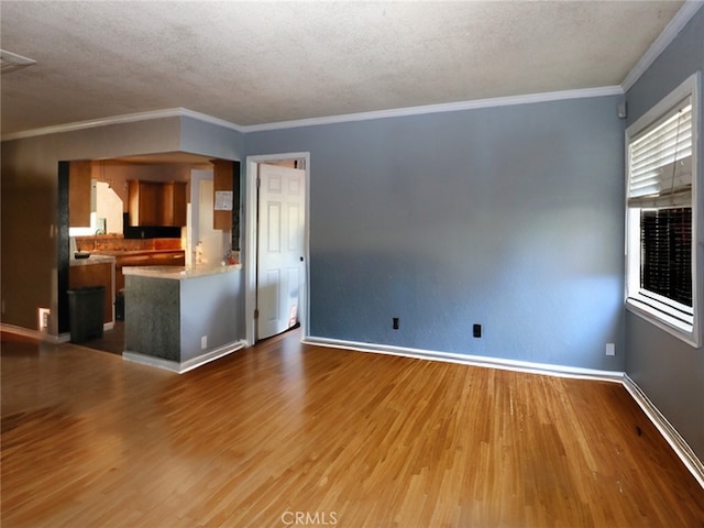 unfurnished living room featuring wood-type flooring, crown molding, and a textured ceiling