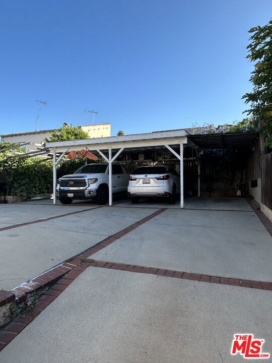 view of vehicle parking with a carport