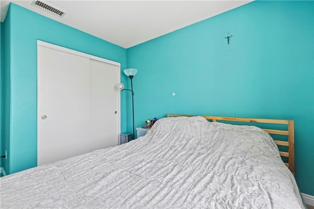 bedroom featuring visible vents and a closet