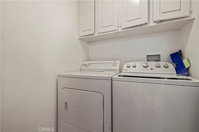 laundry room with cabinet space and washer and clothes dryer