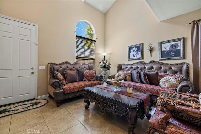 living area with light tile patterned floors and high vaulted ceiling