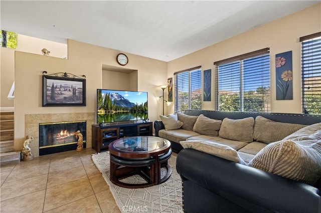 living area featuring a tiled fireplace and tile patterned floors