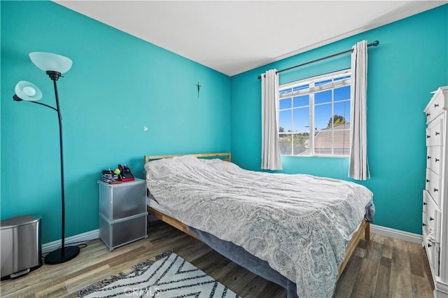 bedroom featuring baseboards and wood finished floors