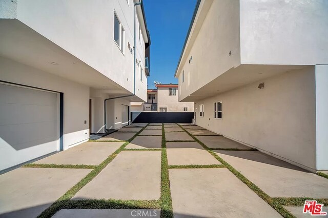 view of side of property with a patio area