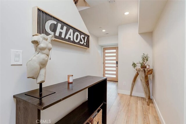 hallway with light hardwood / wood-style floors