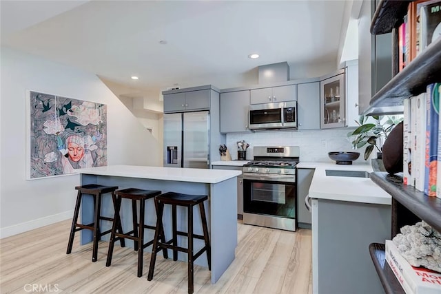 2151 S W View St, Los Angeles, CA 90016 - kitchen with stainless steel appliances, gray cabinets, light wood-style flooring, light countertops, and recessed lighting