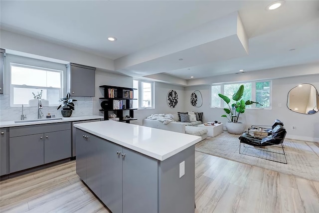 2151 S W View St, Los Angeles, CA 90016 - kitchen with gray cabinetry, a kitchen island, light countertops, light wood finished floors, and recessed lighting