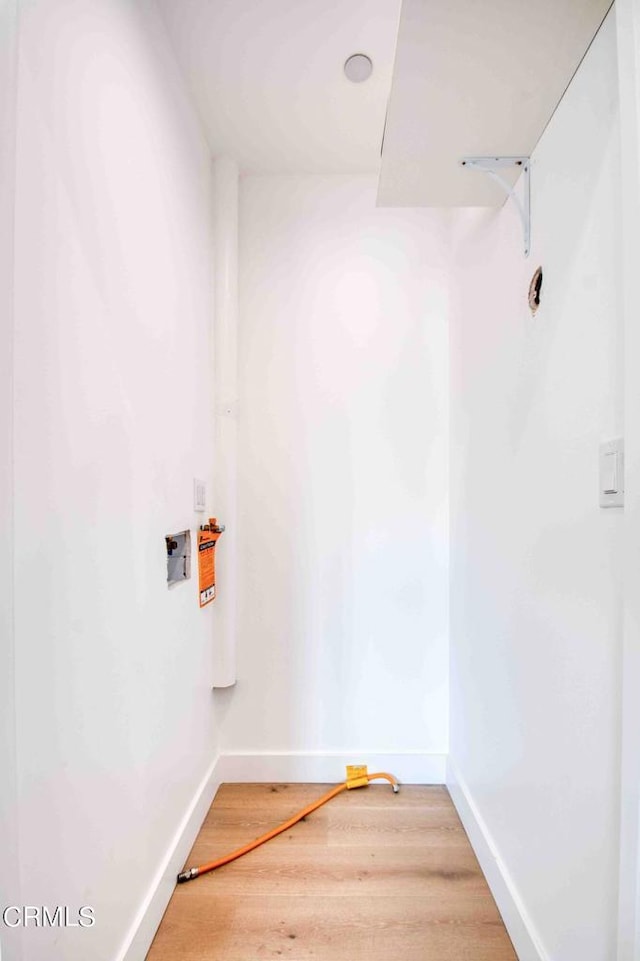 laundry room with wood-type flooring and hookup for a washing machine