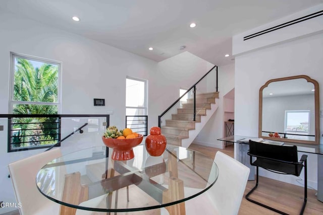 dining room with light wood-type flooring and a wealth of natural light